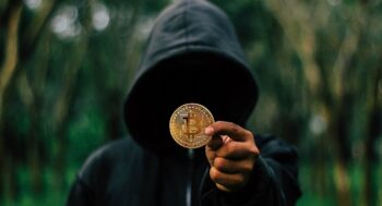 person holding bitcoin coin