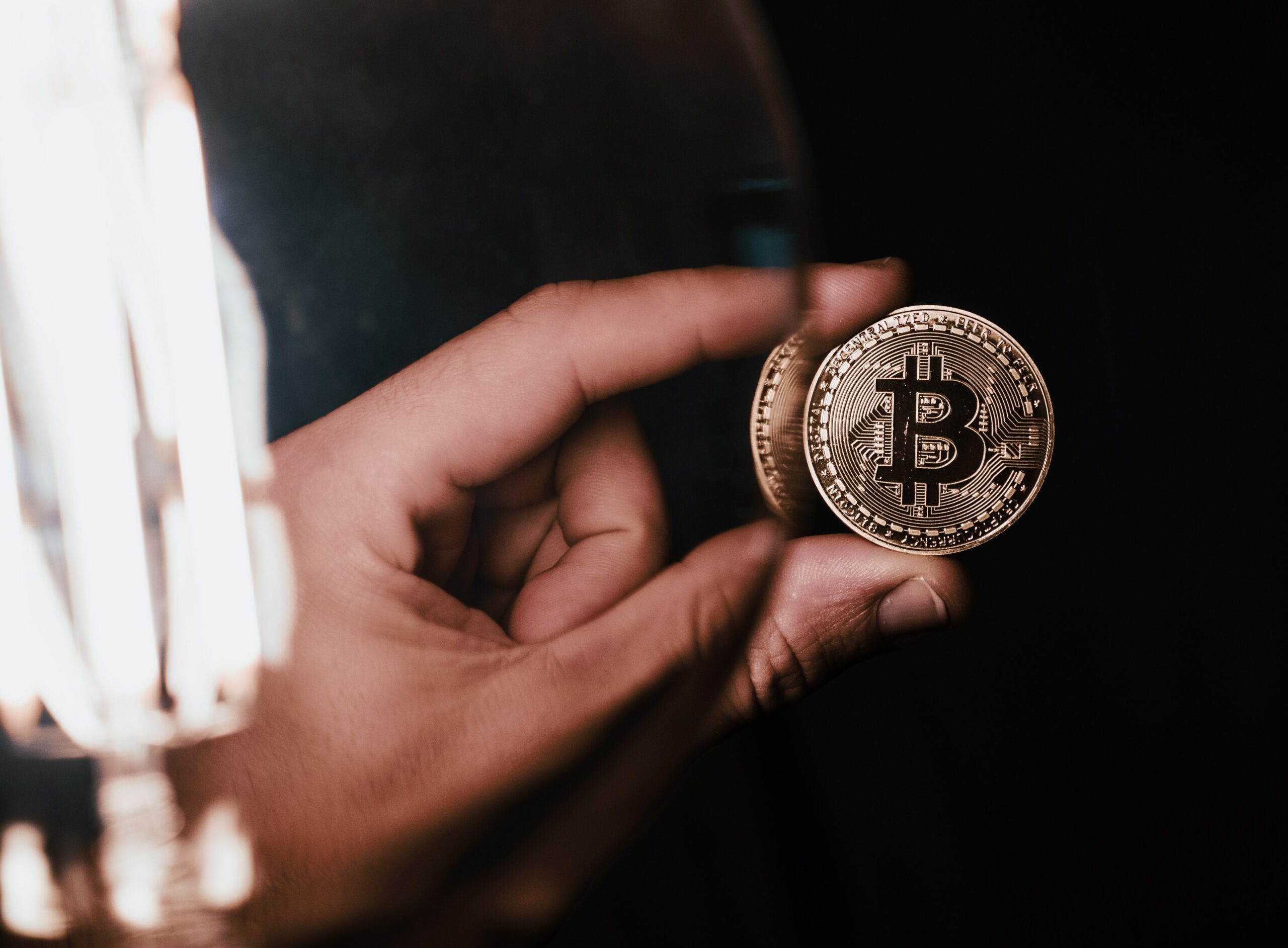 person holding bitcoin coin